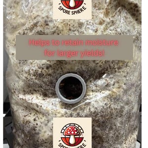 May include: A clear plastic bag filled with a substrate mix, featuring a circular opening and a logo with a red and white mushroom design. Text on the bag reads, "Helps to retain moisture for larger yields!" The logo says "Spore Sphere".