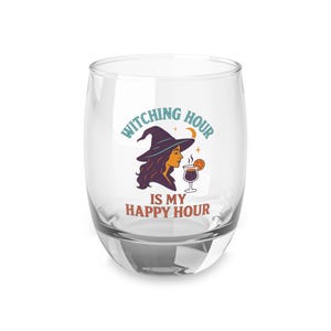 May include: A clear stemless wine glass with the words "Witching Hour Is My Happy Hour" printed on it. The design features a witch with purple hair and a black hat, a crescent moon, and a cocktail.