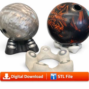 May include: Two bowling balls resting on 3D-printed stands, one silver and one black with orange spider graphics and the text BLACK WIDOW. A separate white stand with circular inserts is in the foreground. Includes a Digital Download STL File button.