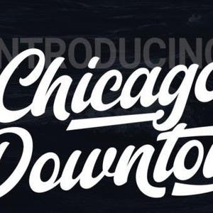 May include: A graphic design display featuring the white text "INTRODUCING" in a small sans-serif font above the large, bold, white script lettering "Chicago Downton". A small circular logo on the right reads "BOLD SCRIPT FONT BY MYN TYPE".
