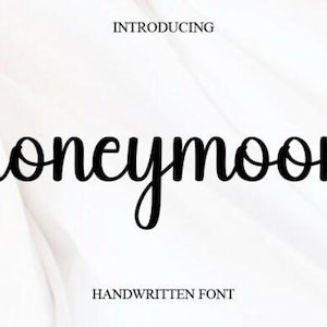 May include: Black script font that reads "honeymoon" on a white background. The word is in a cursive style, with the letters connected. Above the word is the word "INTRODUCING" and below it is "HANDWRITTEN FONT".