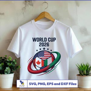 May include: White t-shirt featuring a soccer ball design with the flags of the USA, Canada, and Italy, encircled by red and green arcs. The text "WORLD CUP 2026" is above the ball, with stars. The bottom text reads "SVG, PNG, EPS and DXF Files".