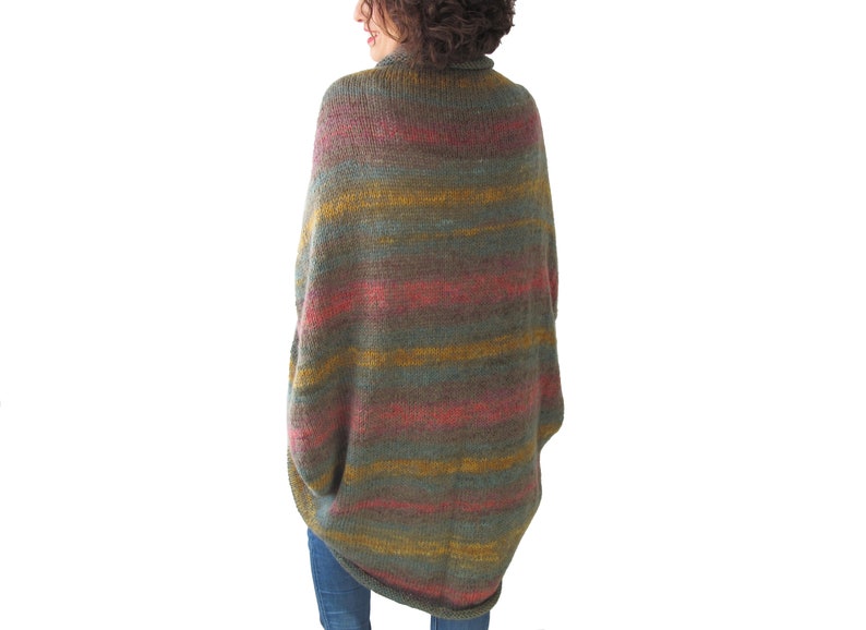 May include: A long, striped, knitted cardigan in shades of green, yellow, and pink. The cardigan has a loose fit and a high neckline.