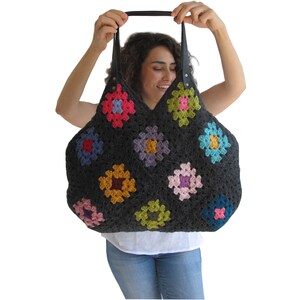 May include: A large, gray crochet tote bag with colorful granny square patches. The bag has leather handles.