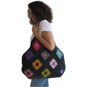 May include: A large black crochet tote bag with colorful granny squares. The bag has a wide opening and is perfect for carrying everyday essentials.
