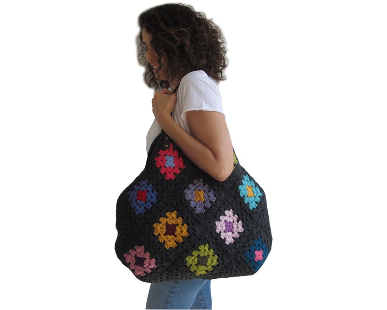 May include: A large black crochet tote bag with colorful granny squares. The bag has a wide opening and is perfect for carrying everyday essentials.