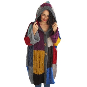 May include: A colorful patchwork cardigan with a hood, featuring a variety of knit textures and a button closure.