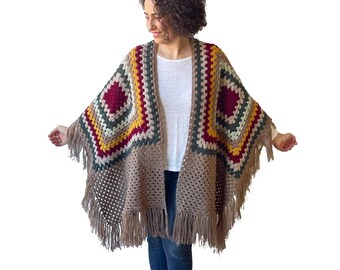 Hand knitted fringed poncho for plus size women, angora wool blend, lightweight and warm, oversized fit L–5XL, perfect winter layering.