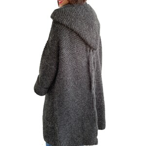 May include: A long, dark gray hooded cardigan sweater with a tie at the back.