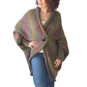 May include: A long, striped cardigan with a shawl collar and a button closure. The cardigan is made of a soft, knitted fabric and is available in a variety of colours.