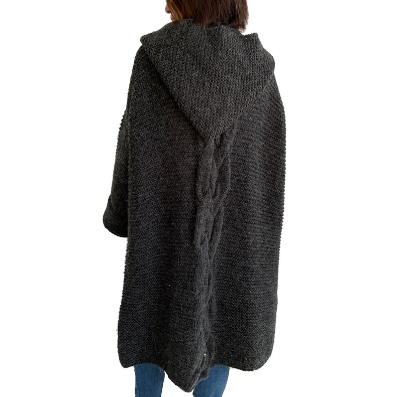 May include: A charcoal gray hooded cardigan with a cable knit design down the back.