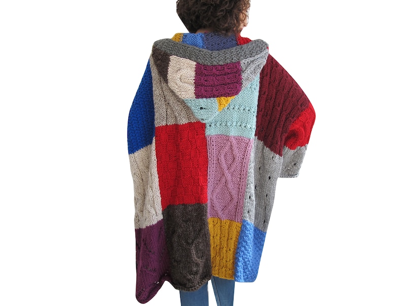 May include: A long, hooded cardigan with a patchwork design. The cardigan is made of different colored yarns, including red, blue, purple, brown, and gray.