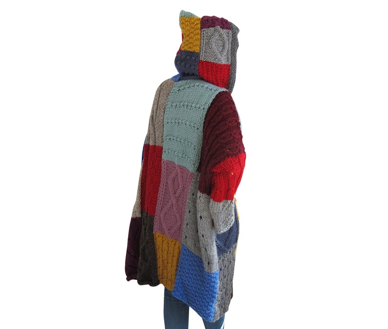 May include: A colorful patchwork knitted cardigan with a hood. The cardigan is made of different colored yarn, including red, blue, green, yellow, and purple. The cardigan has a loose fit and is perfect for layering.