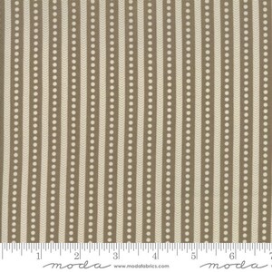 May include: Tan and cream-colored fabric with a vertical stripe pattern. Alternating stripes feature rows of white dots and a chevron design. The fabric is measured in inches along the bottom edge.