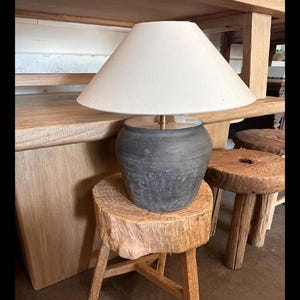 May include: A set of three ceramic vases in varying sizes. The vases feature a matte finish in shades of cream, beige, and brown. The design is minimalist and modern, suitable for home decor.