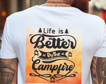 May include: White t-shirt with a graphic print on the back. The graphic is a watercolor-style background with orange and yellow hues. The text on the graphic reads "Life is Better By the Campfire".
