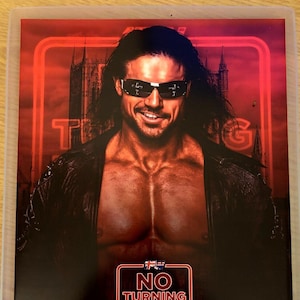 May include: A promotional poster featuring a man with long dark hair and sunglasses. The poster has a red and black color scheme with the words "NO TURNING BACK" and "ONE PRO JOHNNY" displayed prominently.