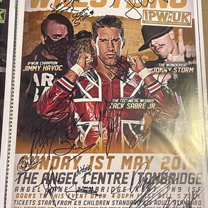 May include: A wrestling event poster featuring three wrestlers and the text "IPW:UK". The poster has multiple signatures and the event details: "SUNDAY 1ST MAY 2015" at "THE ANGEL CENTRE TONBRIDGE". The wrestlers are Jimmy Havoc, Zack Sabre Jr., and Jonny Storm.