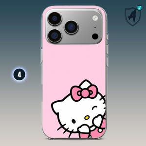 May include: Pink iPhone case featuring a Hello Kitty design. The case has a clear border and a pink background. The Hello Kitty graphic includes a pink bow and is winking. The phone case has a camera bump with three lenses.