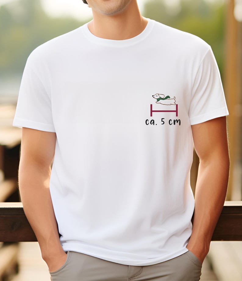 May include: White t-shirt with a small graphic of a dog jumping over a hurdle. The text "ca. 5 cm" is printed below the graphic.