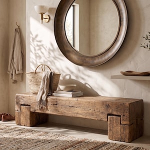 May include: A rectangular bench crafted from thick, weathered brown timber with visible wood grain and joinery details. The bench features a low-profile design with sturdy block legs, providing a solid seating surface for an entryway or living space.