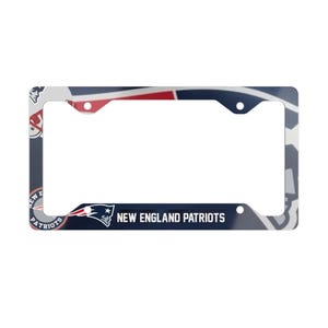 May include: Rectangular license plate frame with a navy blue, red, and white design. The frame features the words "NEW ENGLAND PATRIOTS" in white text. The frame has the team logo and a graphic of the team's mascot.