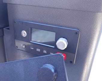 May include: Close-up of a black control panel with a digital display, a knob, and several buttons labeled "Timer", "Super Smoke", "Keep Warm", and "Menu".