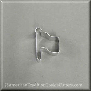 May include: A silver metal cookie cutter shaped like a flag on a pole.