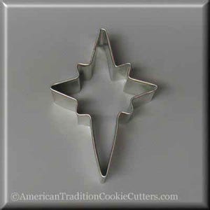 May include: A silver metal cookie cutter shaped like a star with a pointed tip. The star has a simple design with five points.
