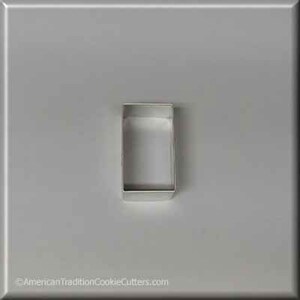 May include: A silver metal cookie cutter shaped like a rectangle.