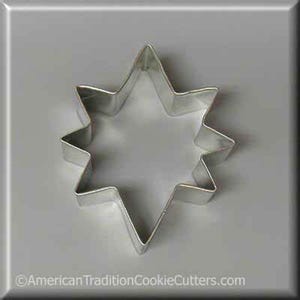 May include: A silver metal cookie cutter shaped like a star with eight points.