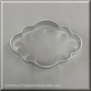 May include: A silver metal cookie cutter shaped like a cloud with a smooth, rounded edge.