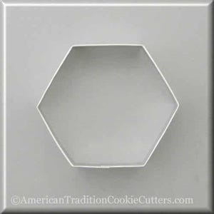 May include: A silver metal cookie cutter shaped like a hexagon. The cutter is on a gray background.