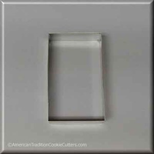 May include: A silver metal cookie cutter shaped like a rectangle. The cutter is on a gray background.