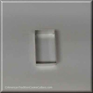 May include: A silver metal cookie cutter shaped like a rectangle.
