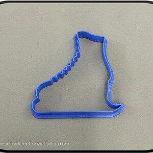 May include: Blue plastic cookie cutter shaped like an ice skate.