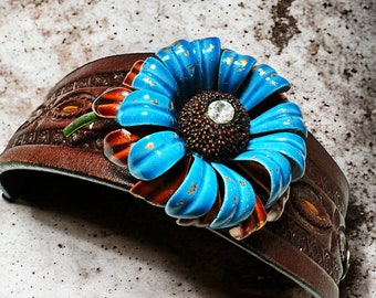 Vintage leather cuff bracelet with a blue enamel pin and a rhinestone button