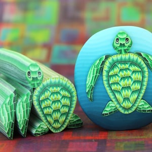 May include: Two green sea turtle sculptures, one is a flat round piece with a blue background, the other is a 3D sculpture of a turtle with a striped green and white shell.