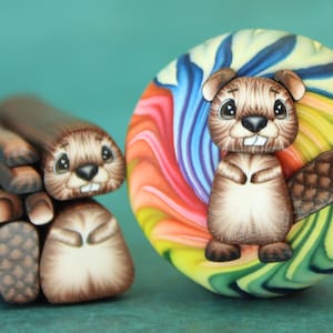 May include: A whimsical polymer clay sculpture featuring a cartoon beaver with a brown body, large eyes, and a buck-toothed grin. The beaver is next to a colorful swirl design and a stack of logs.