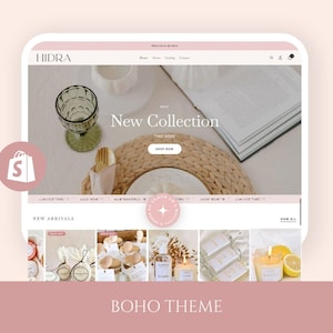 May include: A website mockup with a soft pink and white color scheme, showcasing a "New Collection" banner. The site features a shopping bag icon and the text "BOHO THEME" at the bottom. The website displays various products, including candles and decorative items.