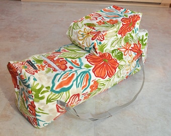 May include: A white yoga mat bag with a floral print in shades of orange, green, and blue. The bag has a zipper closure and a long strap.