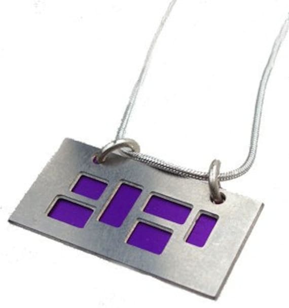 silver pendant with Purple and jet cutouts