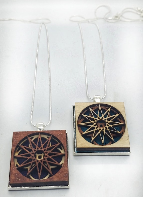 Abstract 1 pendant of plywood,redwood and felt set into stainless steel