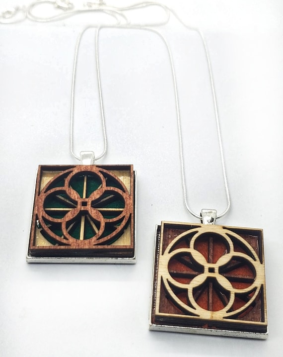 Abstract 2 pendant of plywood,redwood and felt set into stainless steel