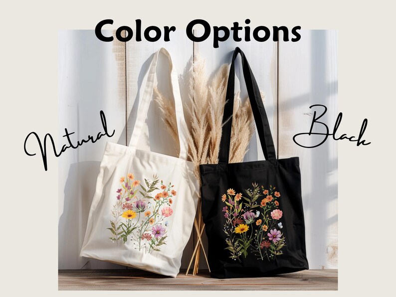 Natural colored canvas tote and black canvas tote hung next to each other. Cottage core style wildflowers of yellow, orange, purple, and pink are center arranged in a rectangular shape and printed on the tote.