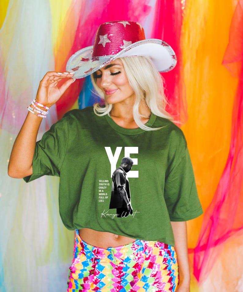 May include: Green t-shirt with the word "YE" in white block letters and a black and white image of a man. The shirt also features the text "Telling truth is crazy in a world full of lies" and the name "Kanye West". A sequined cowboy hat with stars.