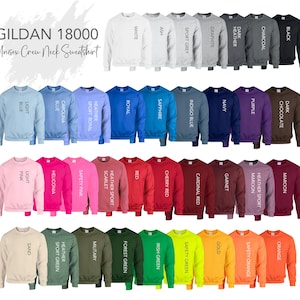 May include: A collection of Gildan 18000 unisex crew neck sweatshirts in various colors, including white, black, blue, pink, and green. The image displays a wide range of hues, with each sweatshirt labeled with its respective color name. The text "Unisex Crew Neck Sweatshirt" is visible.