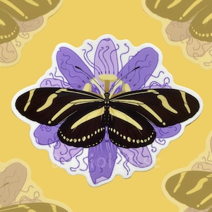 May include: A sticker featuring a black and yellow striped butterfly with a white border, centered on a purple flower design. The background is yellow with additional butterfly and flower elements.