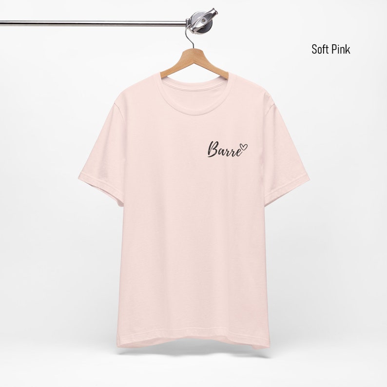May include: A soft pink t-shirt with a black graphic that says "Barre" with a heart symbol.