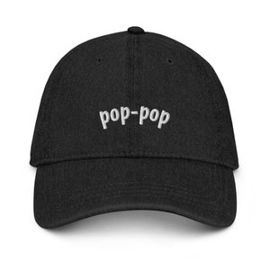 May include: A black baseball cap with the text "pop-pop" embroidered in white on the front.